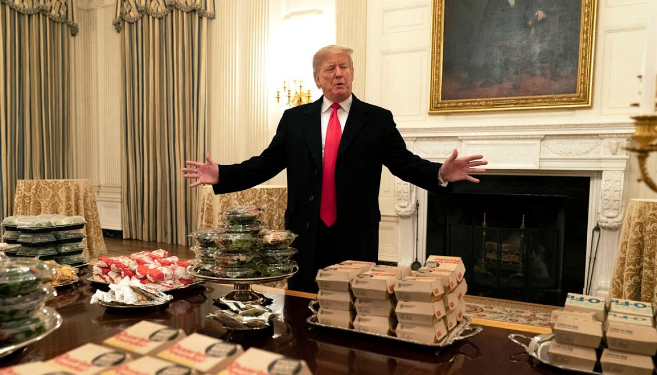 US President Donald Trump serves football team McDonald's burgers at